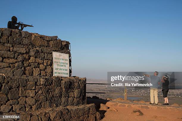 Tourist overviewing the Israeli Syrian border from Mount Bental near Kibutz Merom Golan on August 31, 2013 in the Israeli-annexed Golan Heights....