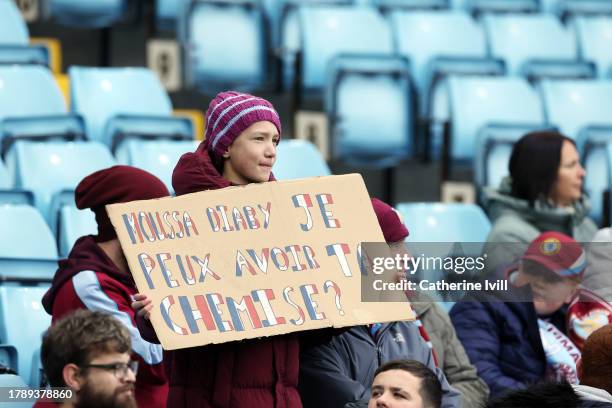 Young Aston Villa fan holds a banner which reads 'Mouse Diaby je peux avoir ta chemise?', translating to 'Moussa Diaby can I have your shirt?', prior...