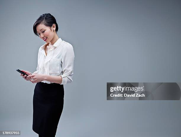 chinese businesswoman using mobile phone, portrait - business person white background stock pictures, royalty-free photos & images