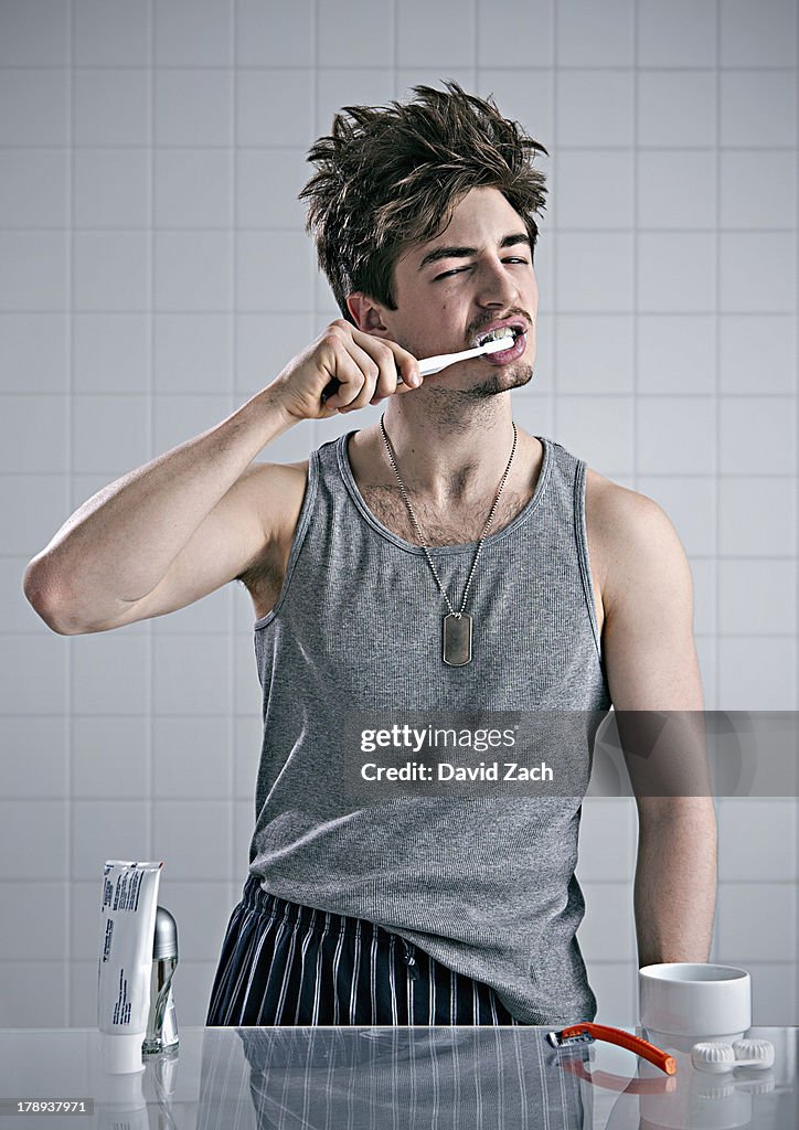 Young man brushing teeth
