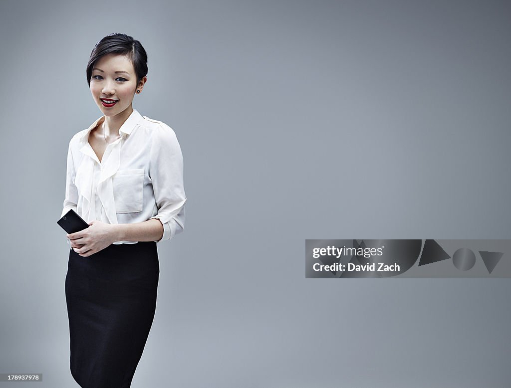 Chinese businesswoman holding mobile phone