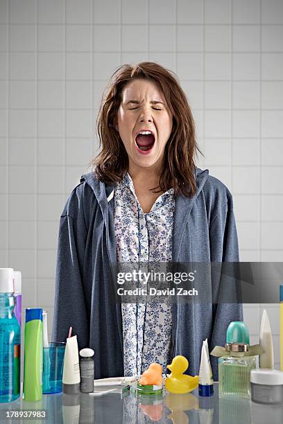 young woman in bathroom, yawning - pajamas stock pictures, royalty-free photos & images
