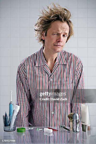 young man in pajamas with messy hair - strubbelhaar mann stock-fotos und bilder