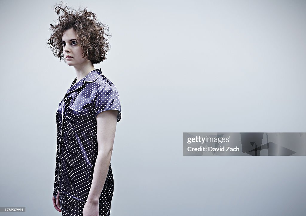 Young woman in pajamas, side view, portrait