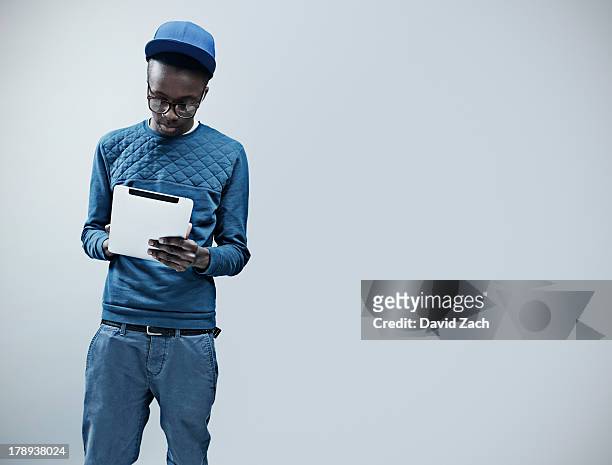 young man using digital tablet - standing to attention stock pictures, royalty-free photos & images