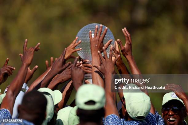 Max Homa of the United States is surrounded by a crowd of ground staff as he holds the trophy after winning the tournament during Day Four of the...