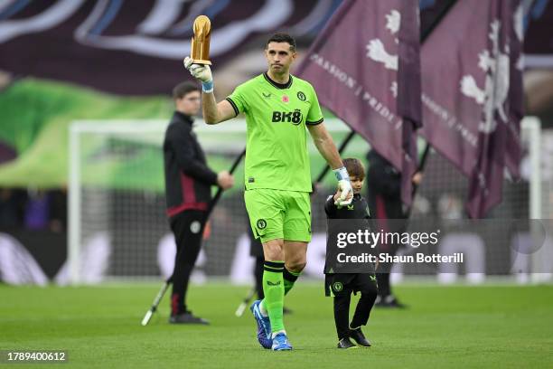 Emiliano Martinez of Aston Villa acknowledges the fans whilst holding his Yashin Trophy prior to kick-off ahead of during the Premier League match...