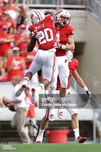 Jared Abbrederis of the Wisconsin Badgers celebrates with James White after making a touchdown during the game against the UMass Minutemen at Camp...