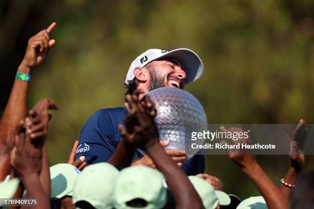 Max Homa of the United States is surrounded by a crowd of ground staff as he holds the trophy after winning the tournament during Day Four of the...