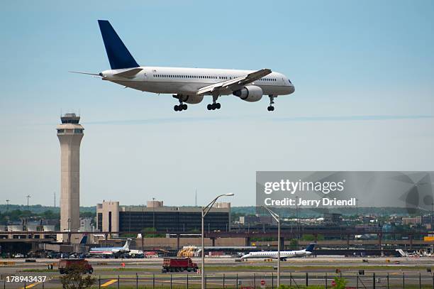 plane landing at newark liberty airport. - newark stock-fotos und bilder