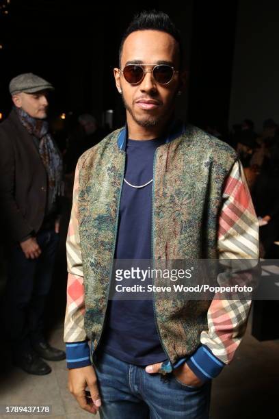 Backstage at the Vivienne Westwood show during Paris Fashion Week Autumn/Winter 2016/17, racing driver Lewis Hamilton wears a floral print bomber...