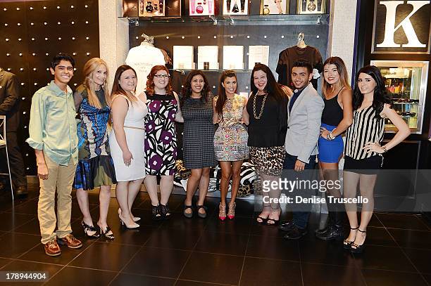 Cici Bussey and Kourtney Kardashian pose for photos with Kardashian Khaos Kuties at Kardashian Khaos at The Mirage Hotel & Casino on August 31, 2013...