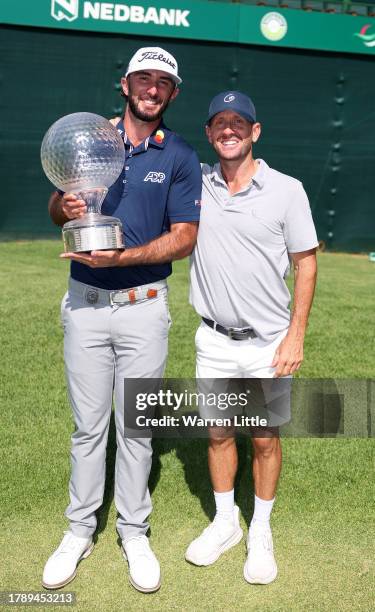 Max Homa of the United States poses with his caddie, Ben Marsh after winning the Nedbank Golf Challenge at Gary Player CC on November 12, 2023 in Sun...