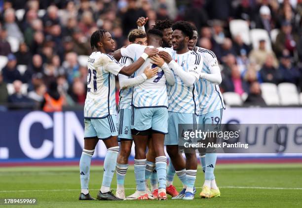 Taiwo Awoniyi of Nottingham Forest celebrates with teammates after scoring the team's first goal during the Premier League match between West Ham...