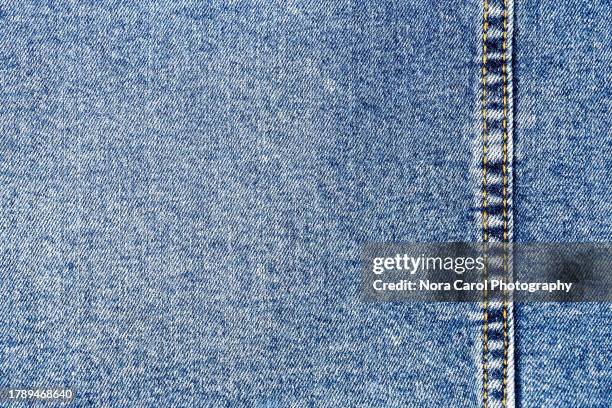 blue denim fabric background - calças de ganga imagens e fotografias de stock