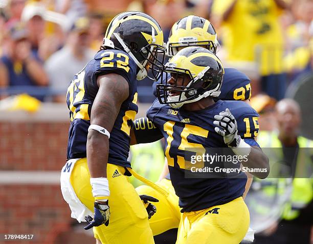 Jarrod Wilson of the Michigan Wolverines celebrates a defending a third down pass with James Ross III while playing the Central Michigan Chippewas in...