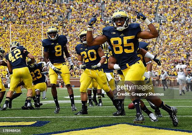 Joe Reynolds of the Michigan Wolverines celebrates returning a first quarter blocked punt for a touchdown while playing the Central Michigan...