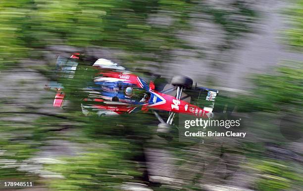 Takuma Sato, of Japan, driver of the A.J. Foyt Enterprises Honda Dallara races past some trees during practice for the Grand Prix of Baltimore on...