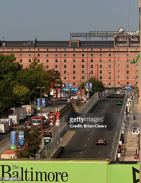 Cars race up a straightaway towards Oriole Park at Camden Yards during for practice for the Grand Prix of Baltimore on August 31, 2013 in Baltimore,...