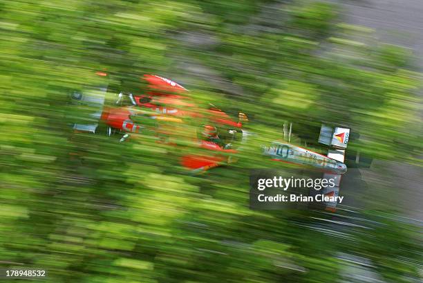 Viso, of Venezuela, driver of the Team Venezuala/Andretti Autosport/HVM Chevrolet Dallara drives his car past some trees during for practice for the...