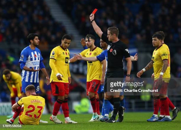 Mahmoud Dahoud of Brighton & Hove Albion receives a red card from referee John Brooks during the Premier League match between Brighton & Hove Albion...