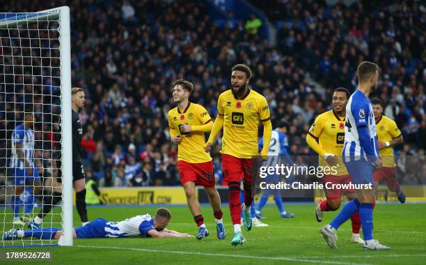 Jayden Bogle of Sheffield United celebrates the teams first goal after Adam Webster of Brighton & Hove Albion scores a own goal during the Premier...