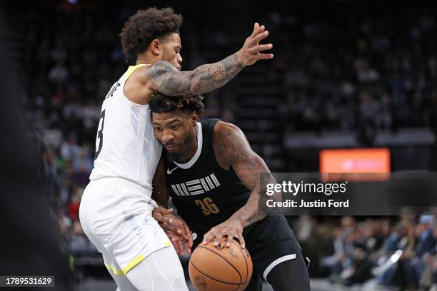 Marcus Smart of the Memphis Grizzlies goes to the basket against Keyonte George of the Utah Jazz during the game at FedExForum on November 10, 2023...