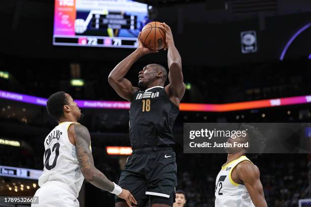 Bismack Biyombo of the Memphis Grizzlies handles the ball against John Collins of the Utah Jazz during the game at FedExForum on November 10, 2023 in...