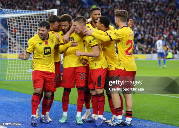 Sheffield United players celebrate their equalising goal put into his own net by Brighton's Adam Webster during the Premier League match between...