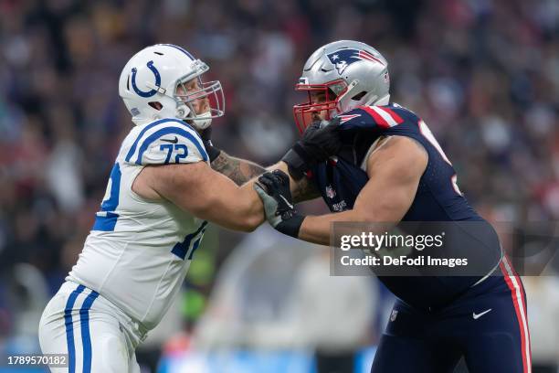 Samson Ebukam of Indianapolis Colts and Lawrence Guy of New England Patriots battle for the ball during the NFL match between Indianapolis Colts and...