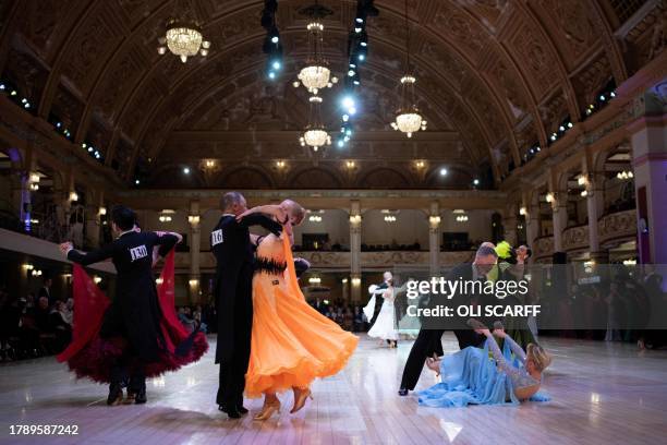 Ballroom dancer Graham Diles picks up his partner Helen Diles after falling whilst competing in the "Over 50's Ballroom Championship" category at the...