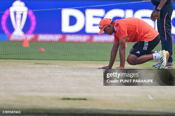 India's coach Rahul Dravid inspects the pitch at the Narendra Modi Stadium in Ahmedabad on November 18 on the eve of their 2023 ICC Men's Cricket...