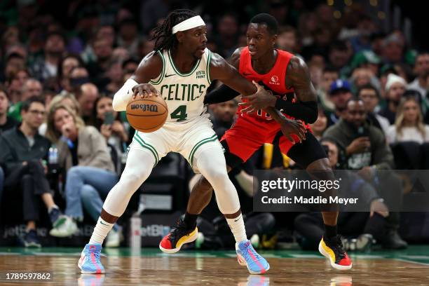 Dennis Schroder of the Toronto Raptors defends Jrue Holiday of the Boston Celtics during the second half at TD Garden on November 11, 2023 in Boston,...