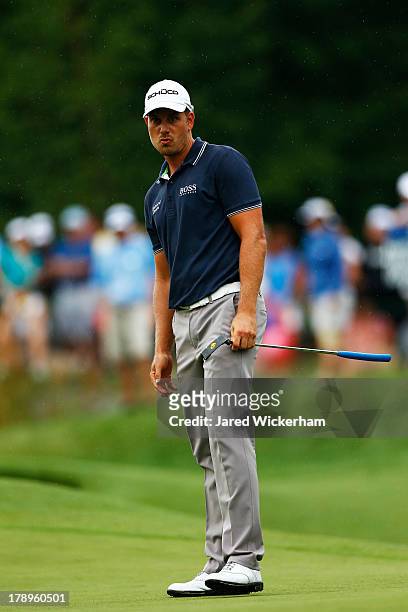 Henrik Stenson of Sweden putts for birdie on the 18th hole during the second round of the Deutsche Bank Championship at TPC Boston on August 31, 2013...