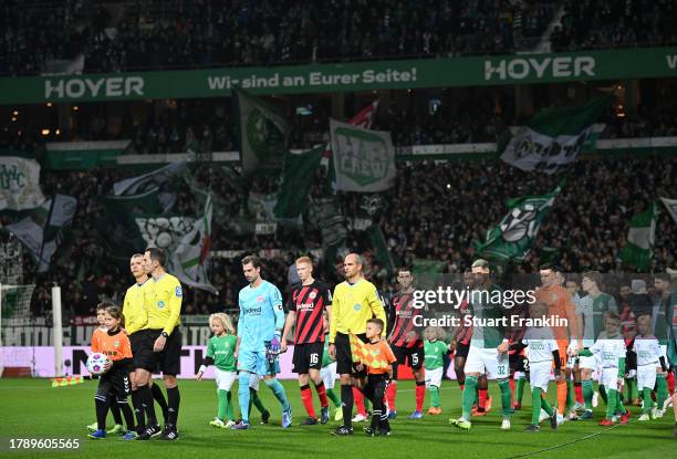 Referee Benjamin Brand leads players out on to the pitch prior to the Bundesliga match between SV Werder Bremen and Eintracht Frankfurt at Wohninvest...