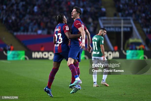 Robert Lewandowski of FC Barcelona celebrates with teammate Jules Kounde after scoring the team's first goal during the LaLiga EA Sports match...
