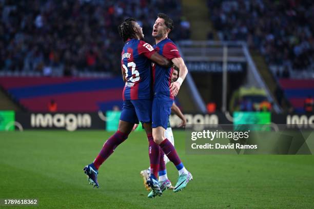 Robert Lewandowski of FC Barcelona celebrates with teammate Jules Kounde after scoring the team's first goal during the LaLiga EA Sports match...