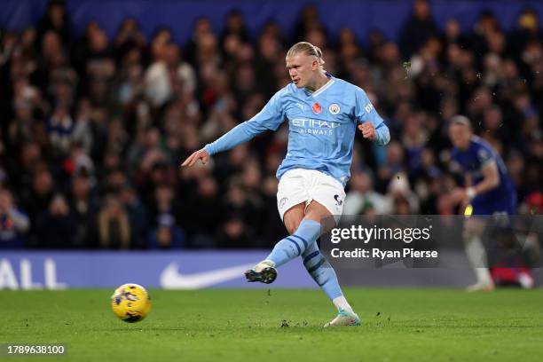 Erling Haaland of Manchester City scores the team's first goal from a penalty during the Premier League match between Chelsea FC and Manchester City...