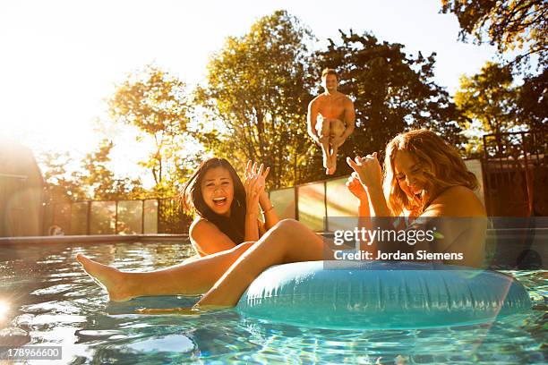 three friends enjoying a day at the pool. - pool party ストックフォトと画像