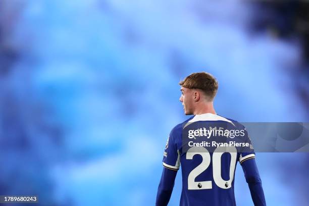 Cole Palmer of Chelsea looks on after a flare is thrown on the pitch during the Premier League match between Chelsea FC and Manchester City at...