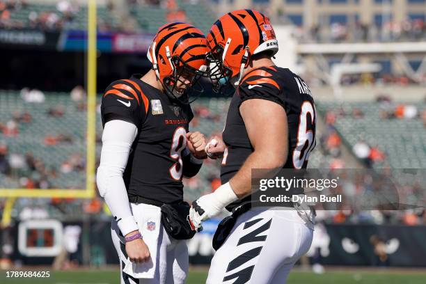 Joe Burrow of the Cincinnati Bengals and Ted Karras of the Cincinnati Bengals talk before the game against the Houston Texans at Paycor Stadium on...