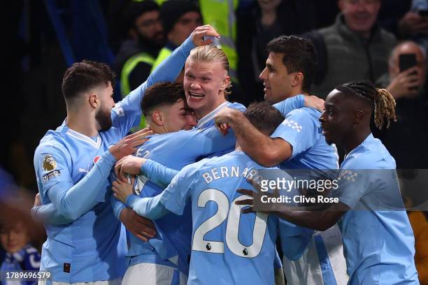 Erling Haaland of Manchester City celebrates with teammates after scoring the team's third goal during the Premier League match between Chelsea FC...
