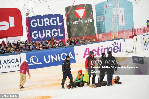 Climate protesters are evacuated by police in the finish area during the Audi FIS Alpine Ski World Cup Men's Slalom on November 18, 2023 in Gurgl,...