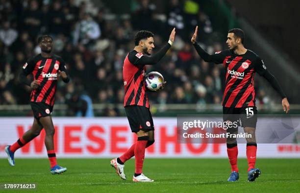 Ellyes Skhiri of Sport-Club Freiburg celebrates with teammate Noah Weisshaupt after scoring the team's first goal during the Bundesliga match between...