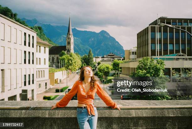 woman walking in  liechtenstein city in summer - liechtenstein cityscape stock pictures, royalty-free photos & images