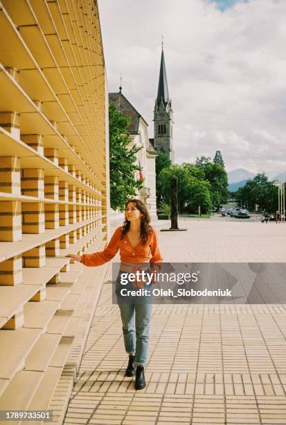 woman walking in  liechtenstein city in summer - liechtenstein cityscape stock pictures, royalty-free photos & images