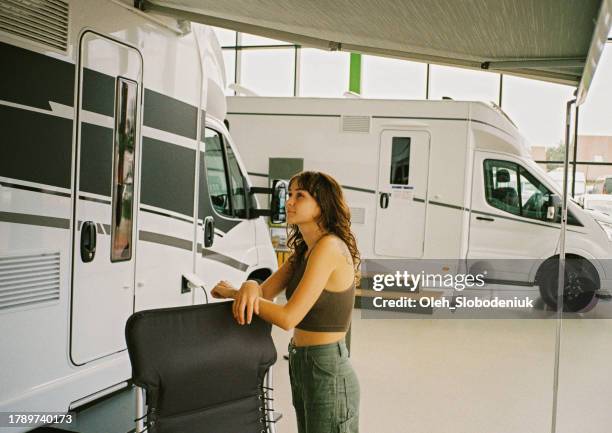 woman in motorhome showroom - camper van stock pictures, royalty-free photos & images