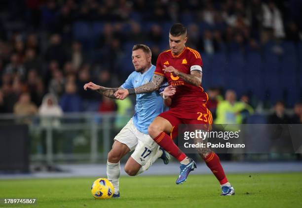 Ciro Immobile of SS Lazio and Gianluca Mancini of AS Roma battle for possession during the Serie A TIM match between SS Lazio and AS Roma at Stadio...