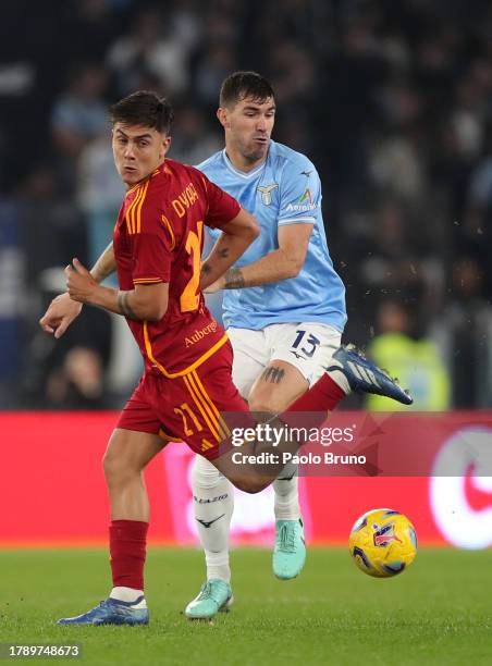 Paulo Dybala of AS Roma is challenged by Alessio Romagnoli of SS Lazio during the Serie A TIM match between SS Lazio and AS Roma at Stadio Olimpico...