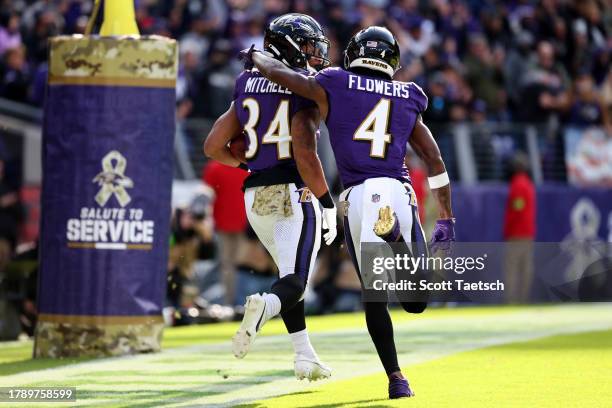 Keaton Mitchell of the Baltimore Ravens celebrates a touchdown with teammate Zay Flowers against the Cleveland Browns during the first quarter at M&T...